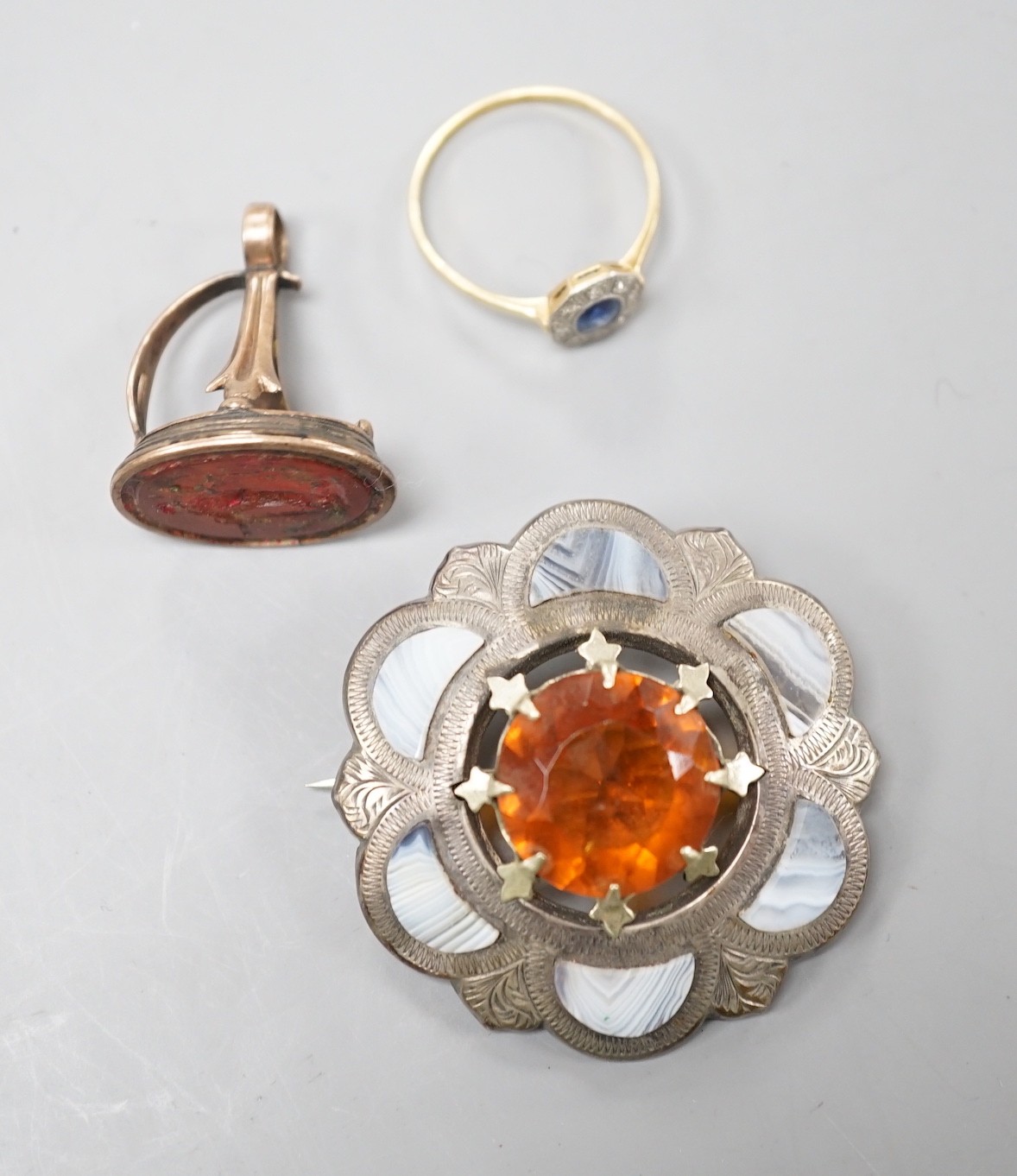 An 18ct, and plat, sapphire and diamond cluster set ring, size T, gross weight 2.3 grams, together with a Scottish hardstone set brooch and a seal(a.f).
